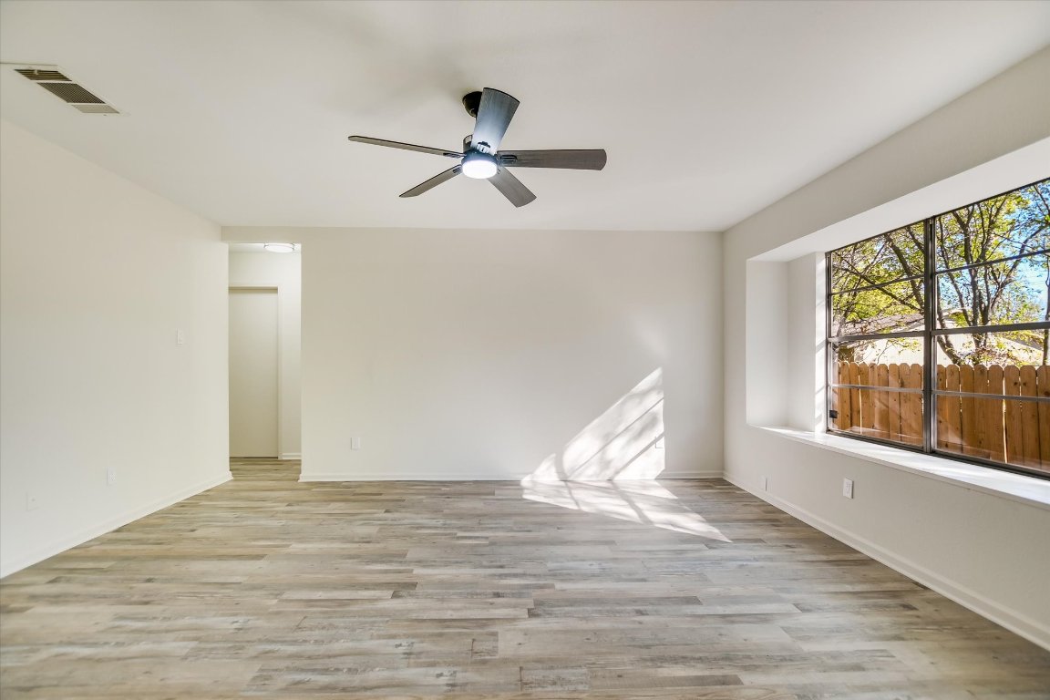 7003 Castlekeep Way Austin, TX 78745 - Photo 5 of 23 a view of an empty room with wooden floor and a window