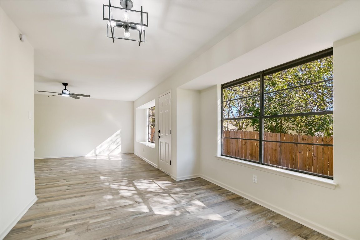 7003 Castlekeep Way Austin, TX 78745 - Photo 7 of 23 a view of empty room with wooden floor and fan
