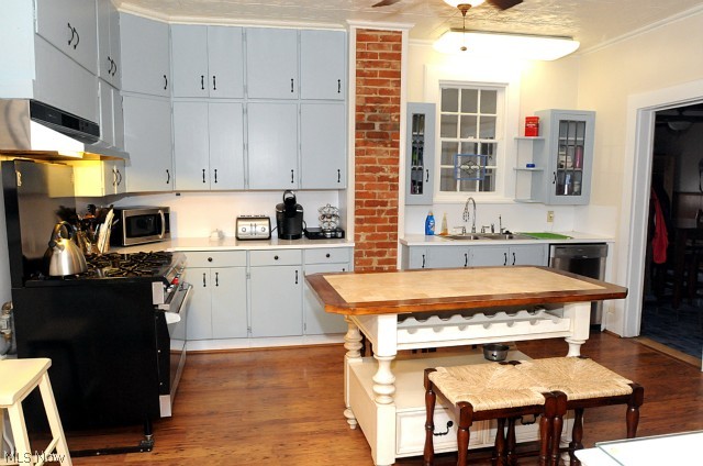 Kitchen with commercial stove and hard wood floors