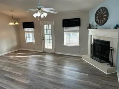 a view of an empty room with window and fireplace