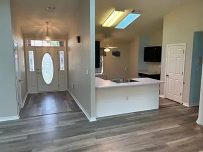 a view hallway with wooden floor and cabinet