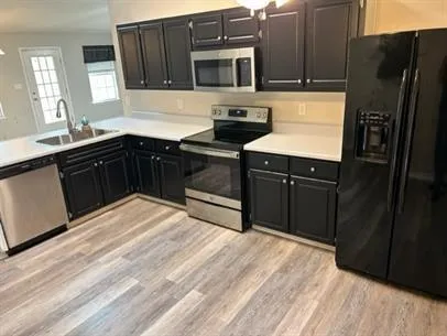 a kitchen with stainless steel appliances granite countertop a refrigerator and a stove top oven