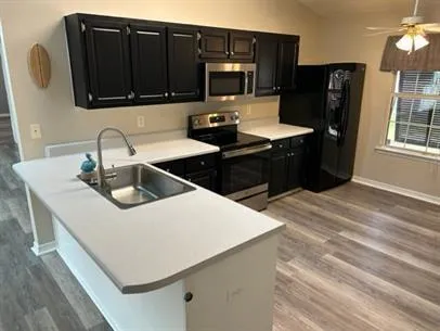 a kitchen with a sink and refrigerator