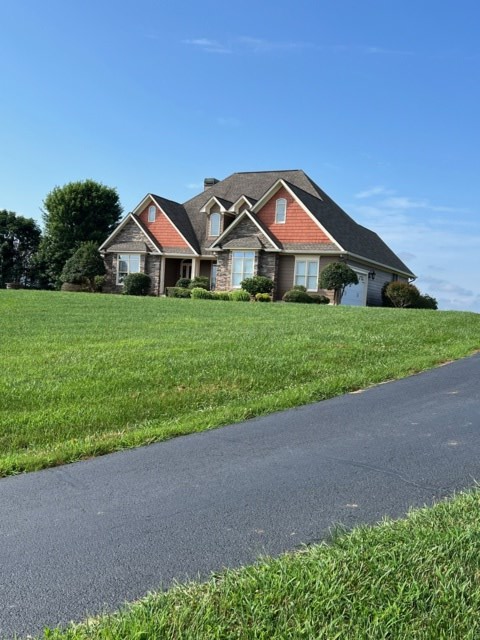85 Ridgemont Lane Ellijay, GA 30536 - Photo 27 of 42 a front view of a house with a yard and garage