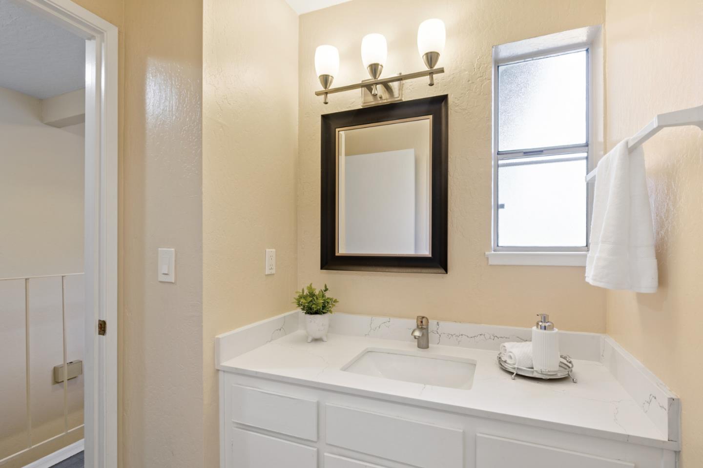 101 Redding Road, Unit A6 Campbell, CA 95008 - Photo 24 of 28 a bathroom with a sink vanity and mirror