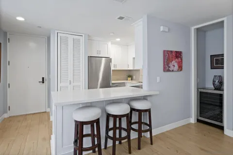 a kitchen with stainless steel appliances a table and chairs