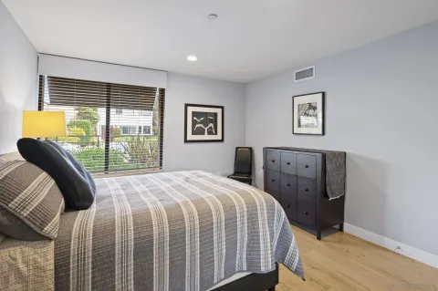 a bedroom with a bed and a large window