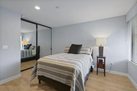 a bedroom with a bed and a mirror