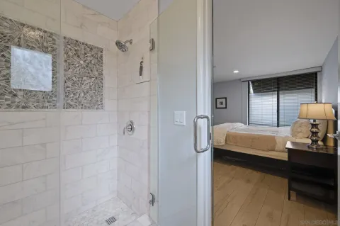 a bedroom with a bed and a chandelier