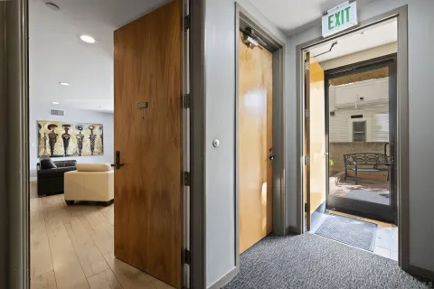 a view of a hallway with living room and couch