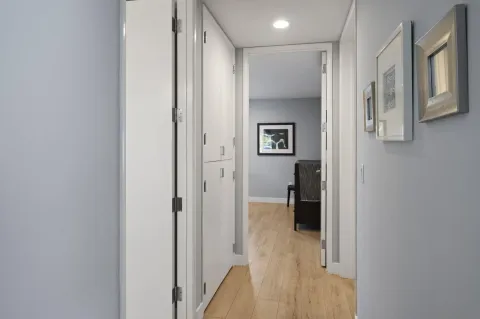 a view of a hallway with wooden shelves