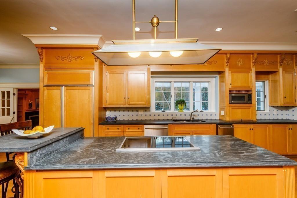 23 MacMillan Drive Concord, MA 01742 - Photo 11 of 41 a kitchen with stainless steel appliances granite countertop a sink and cabinets