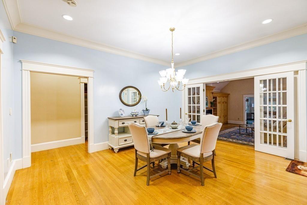 23 MacMillan Drive Concord, MA 01742 - Photo 13 of 41 a view of a dining room with furniture a chandelier and wooden floor