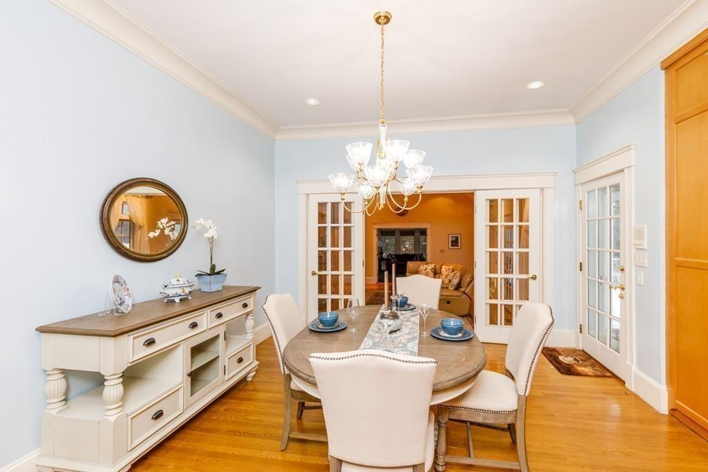 23 MacMillan Drive Concord, MA 01742 - Photo 15 of 41 a view of a dining room with furniture a chandelier and wooden floor
