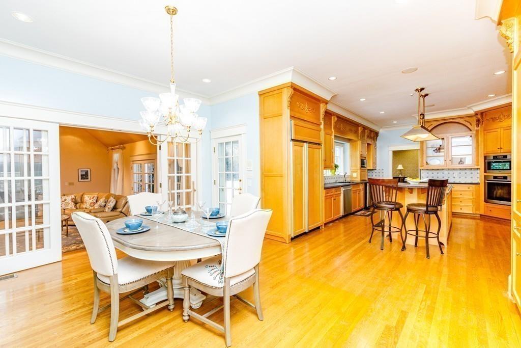 23 MacMillan Drive Concord, MA 01742 - Photo 16 of 41 a dining room with furniture and wooden floor