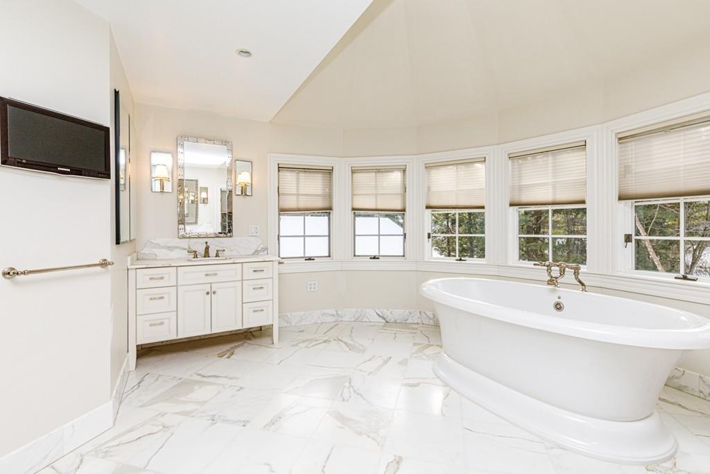 23 MacMillan Drive Concord, MA 01742 - Photo 25 of 41 a bathroom with a bathtub sink and mirror