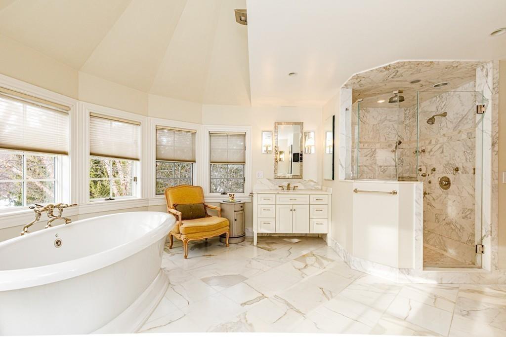 23 MacMillan Drive Concord, MA 01742 - Photo 26 of 41 a bathroom with a tub sink and mirror