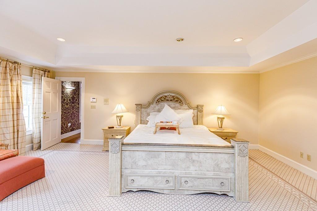 23 MacMillan Drive Concord, MA 01742 - Photo 27 of 41 a bedroom with a bed and large windows