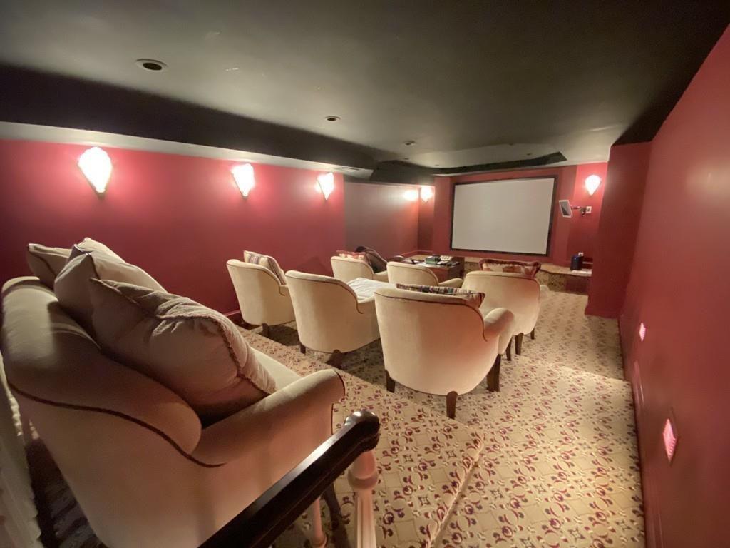 23 MacMillan Drive Concord, MA 01742 - Photo 34 of 41 a living room with furniture a rug and a projector