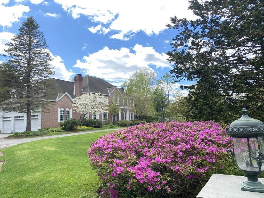 23 MacMillan Drive Concord, MA 01742 - Photo 41 of 41 a front view of a house with a garden