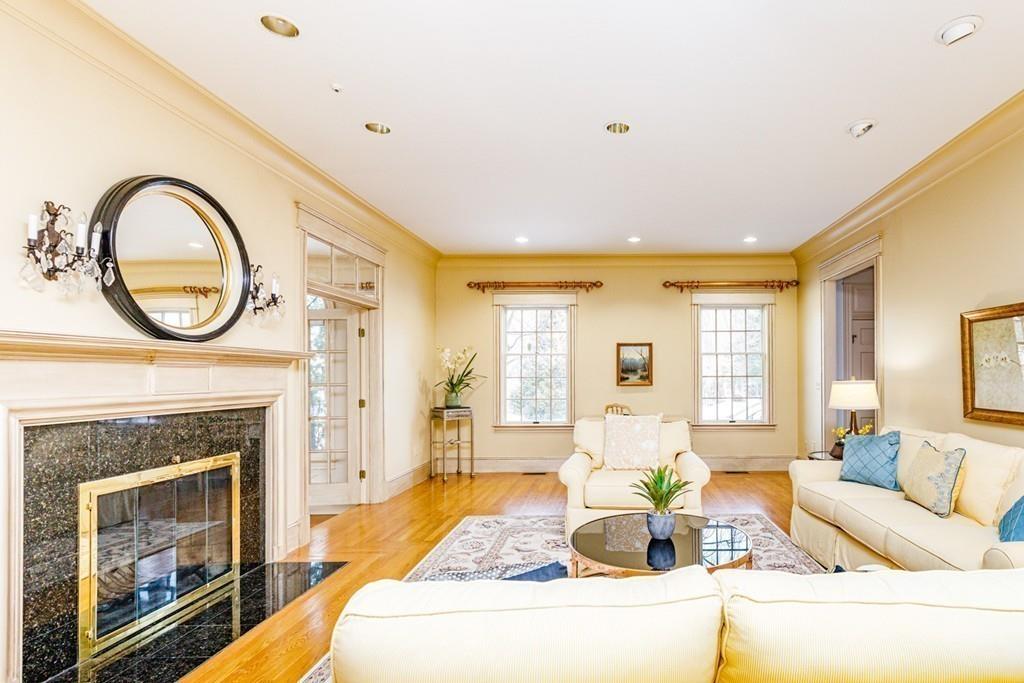 23 MacMillan Drive Concord, MA 01742 - Photo 7 of 41 a living room with furniture a fireplace and a large window