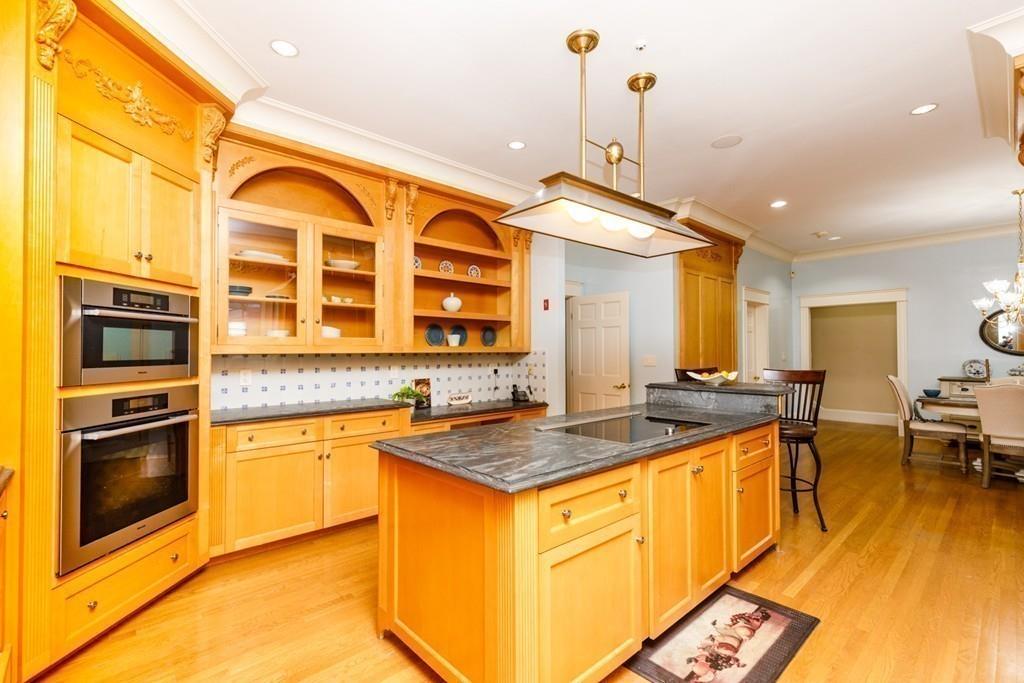 23 MacMillan Drive Concord, MA 01742 - Photo 10 of 41 a kitchen with stainless steel appliances granite countertop a stove and a sink