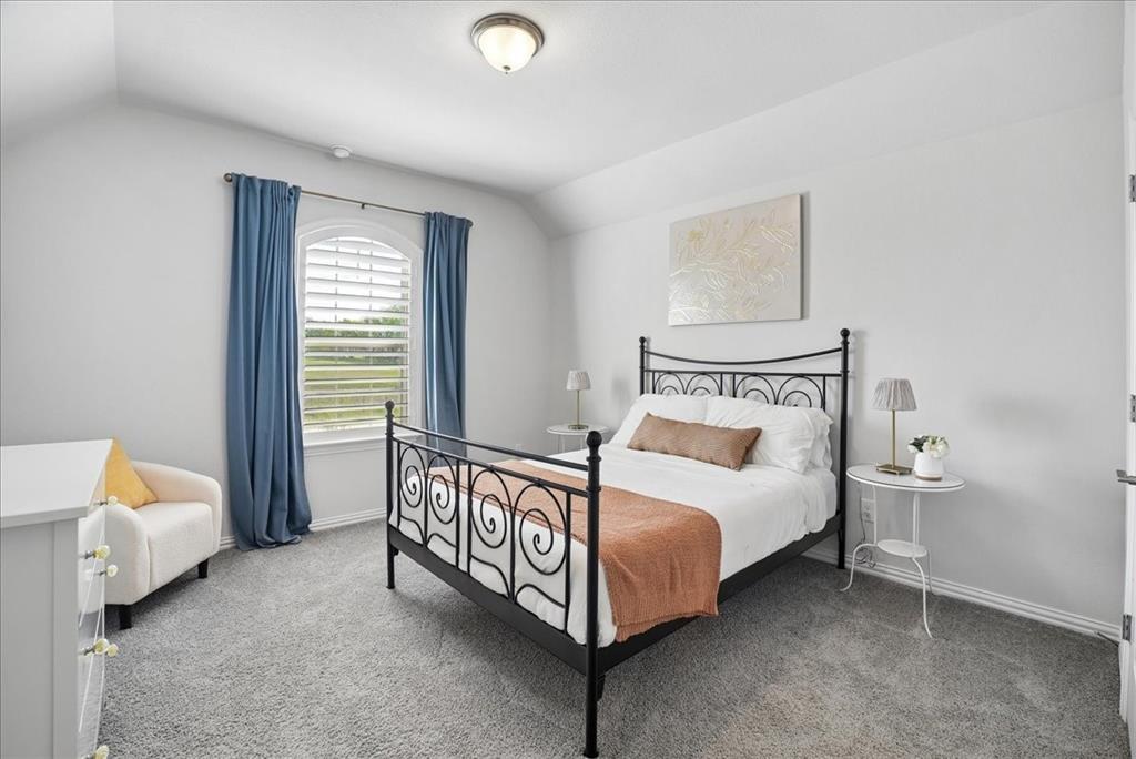 2721 Rotherham Street Prosper, TX 75078 - Photo 21 of 37 a spacious bedroom with a bed and a window