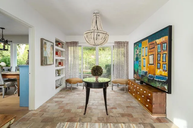 a view of a patio with table and chairs and potted plants