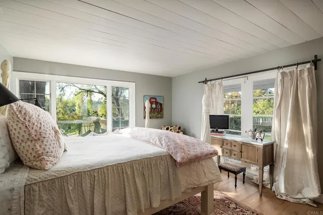 a spacious bedroom with a bed and a fireplace