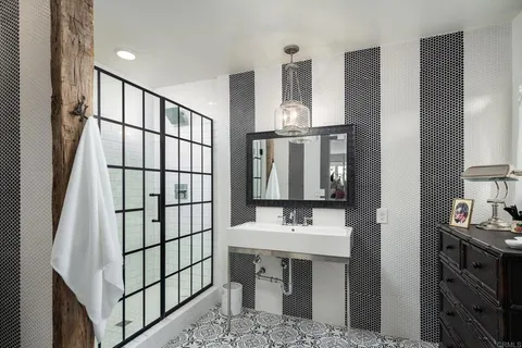 a bathroom with a bathtub and shower
