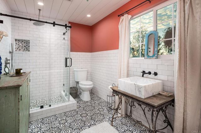 a bathroom with a tub sink and mirror