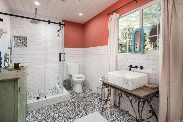 a bathroom with a tub sink and mirror