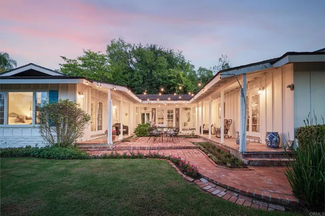 a front view of house with yard and outdoor seating