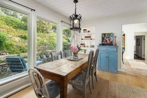a living room with furniture a window and a flat screen tv