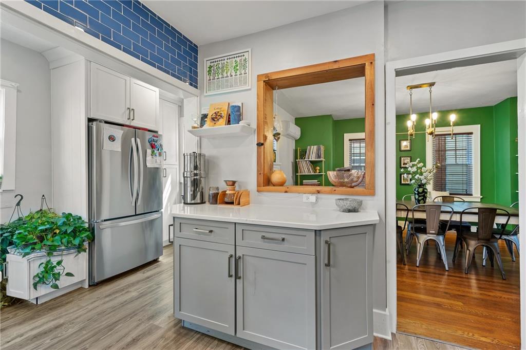 531 Peebles Street Pittsburgh, PA 15221 - Photo 12 of 30 a kitchen with white cabinets and stainless steel appliances