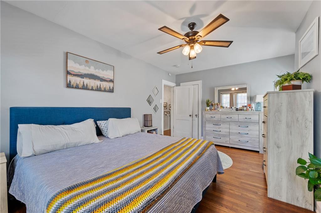 531 Peebles Street Pittsburgh, PA 15221 - Photo 19 of 30 a bedroom with a bed and a chandelier
