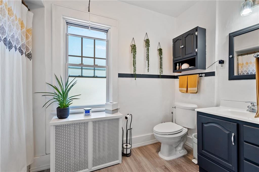 531 Peebles Street Pittsburgh, PA 15221 - Photo 22 of 30 a bathroom with a toilet a sink and mirror