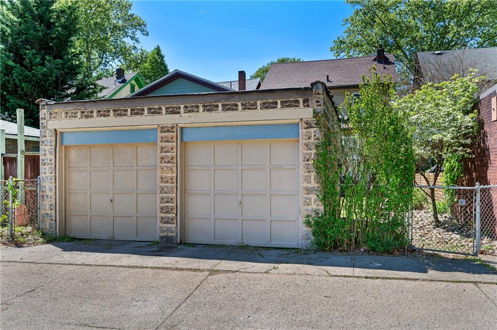 531 Peebles Street Pittsburgh, PA 15221 - Photo 26 of 30 a front view of a house with a garden and parking