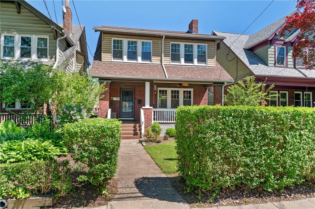 531 Peebles Street Pittsburgh, PA 15221 - Photo 29 of 30 a front view of a house with a yard and potted plants