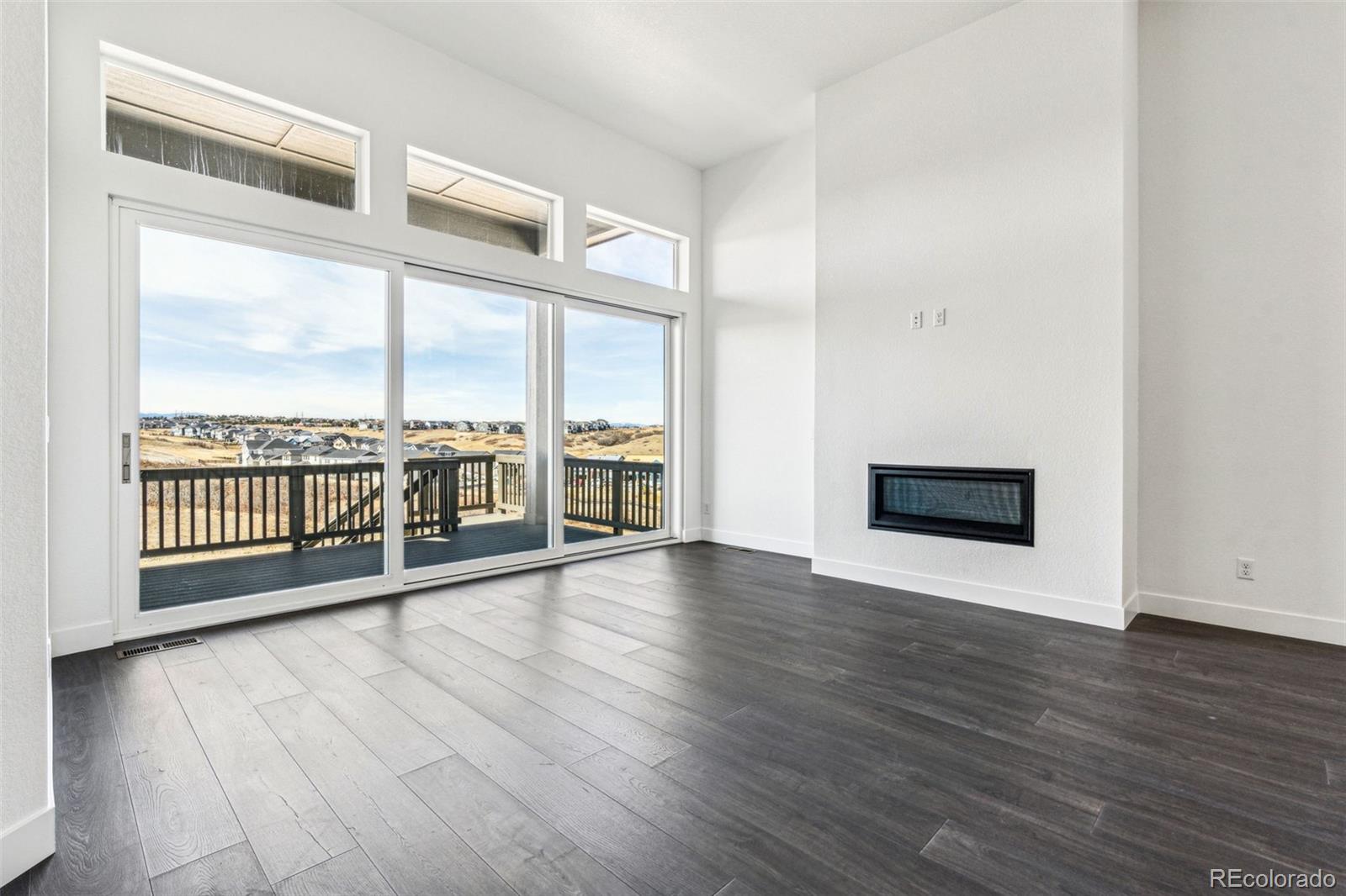 3884 Freestone Point Castle Rock, CO 80108 - Photo 11 of 34 a view of an empty room with wooden floor and a window