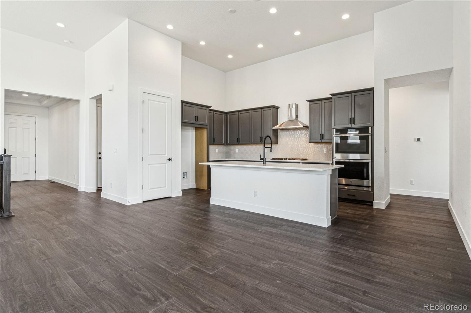 3884 Freestone Point Castle Rock, CO 80108 - Photo 13 of 34 a view of kitchen with wooden floor and electronic appliances
