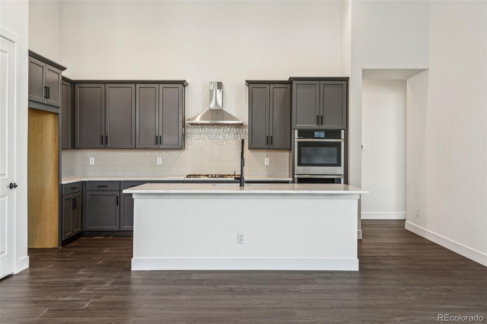 3884 Freestone Point Castle Rock, CO 80108 - Photo 14 of 34 a kitchen with stainless steel appliances granite countertop a stove a sink and a refrigerator