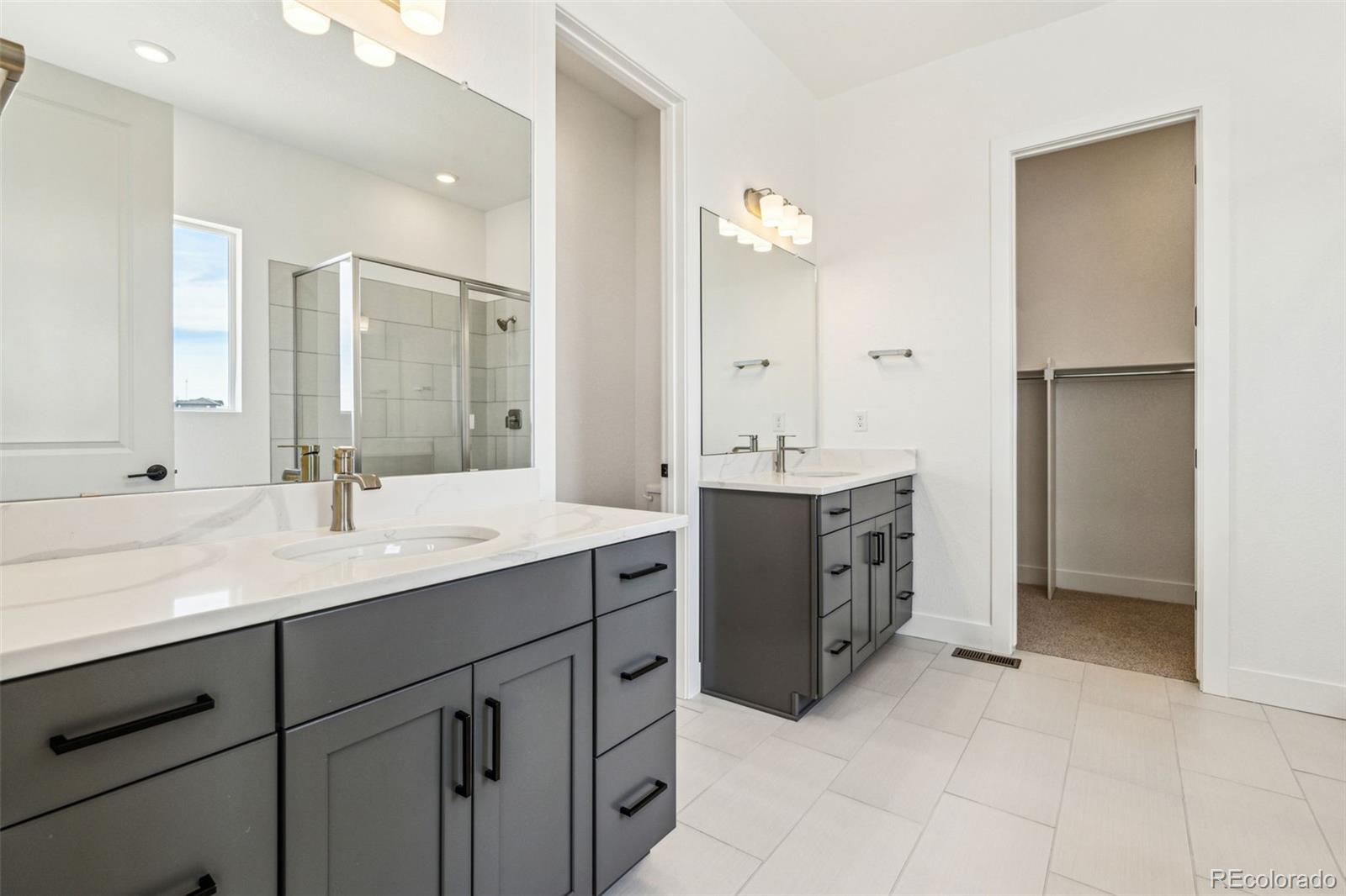 3884 Freestone Point Castle Rock, CO 80108 - Photo 19 of 34 a spacious bathroom with a double vanity sink mirror and