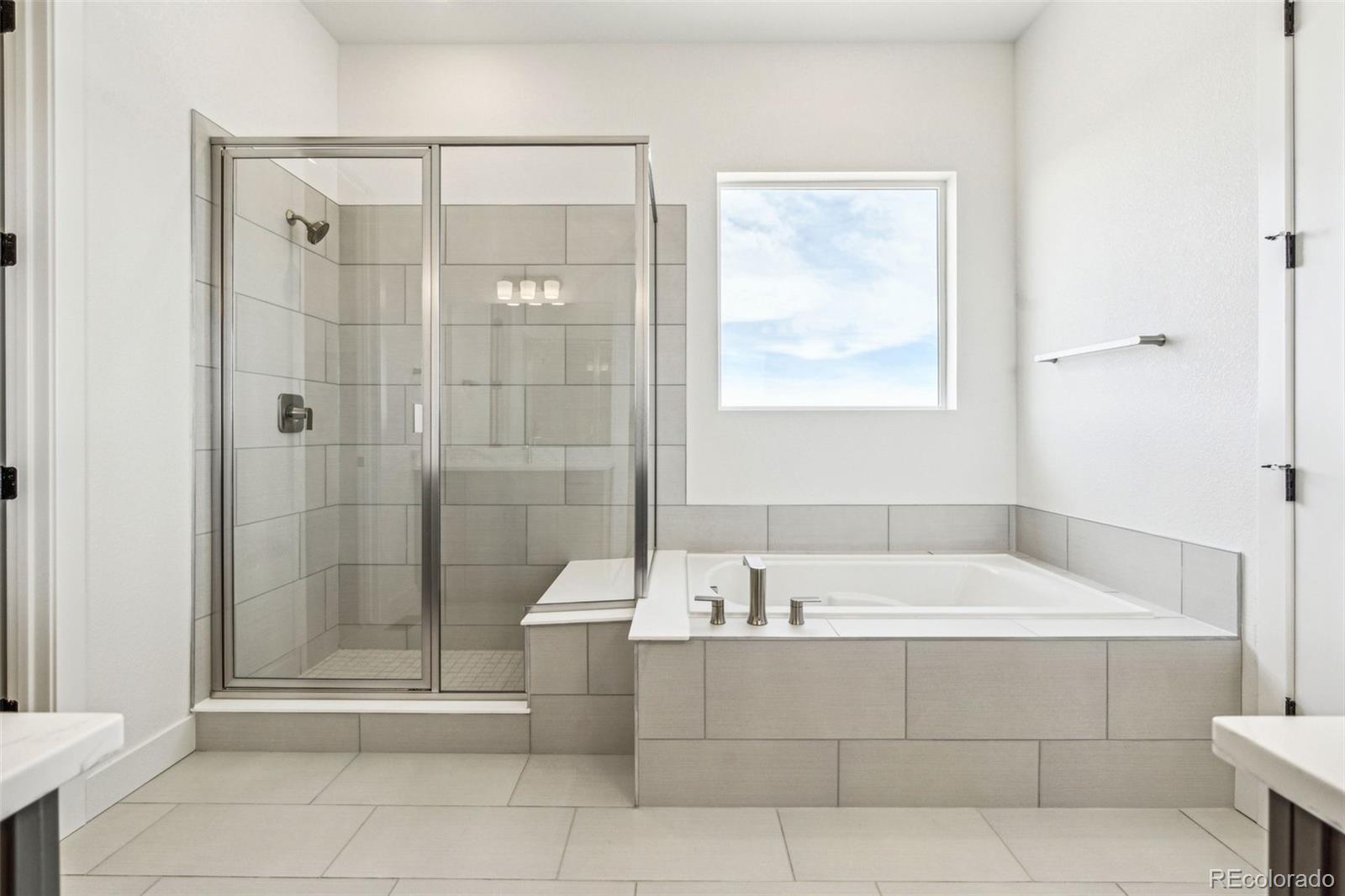 3884 Freestone Point Castle Rock, CO 80108 - Photo 4 of 34 a bathroom with a bathtub and shower