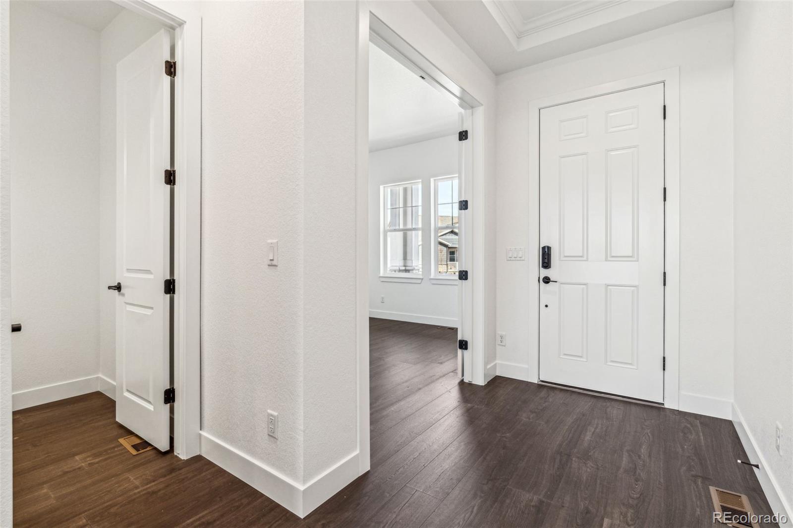 3884 Freestone Point Castle Rock, CO 80108 - Photo 6 of 34 wooden floor with white walls