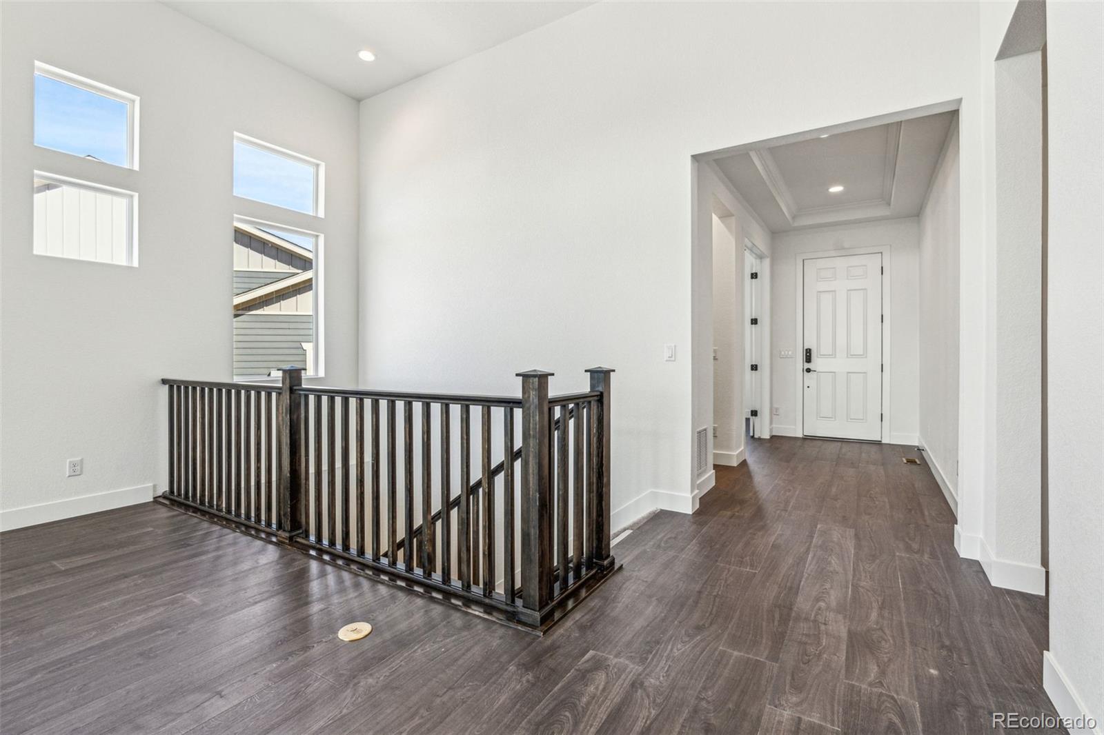3884 Freestone Point Castle Rock, CO 80108 - Photo 7 of 34 a view of a hallway with wooden floor and stairs