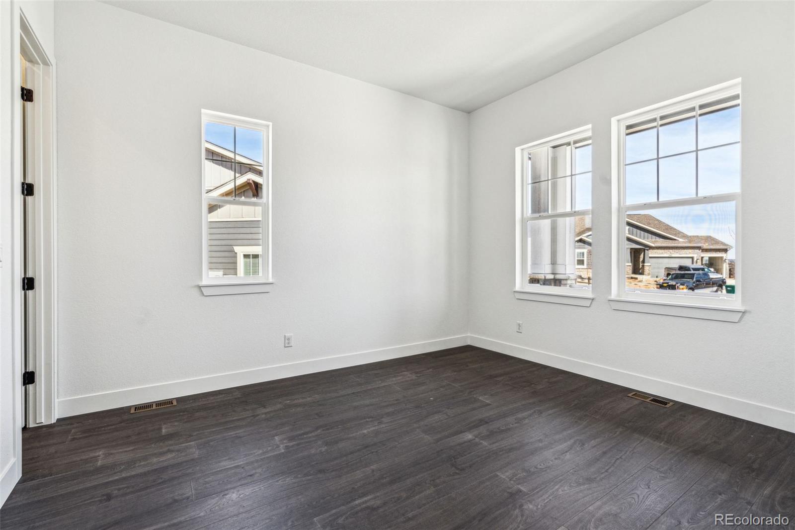 3884 Freestone Point Castle Rock, CO 80108 - Photo 8 of 34 an empty room with wooden floor and windows