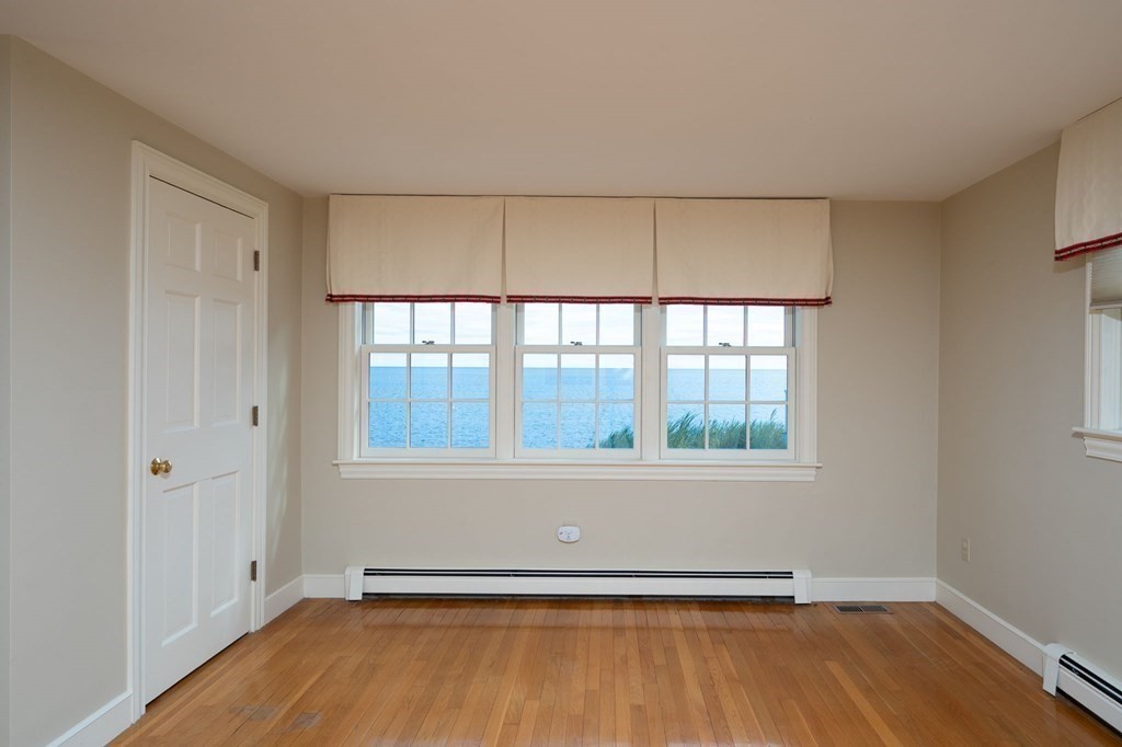 475 Jerusalem Road Cohasset, MA 02025 - Photo 17 of 41 an empty room with wooden floor and windows