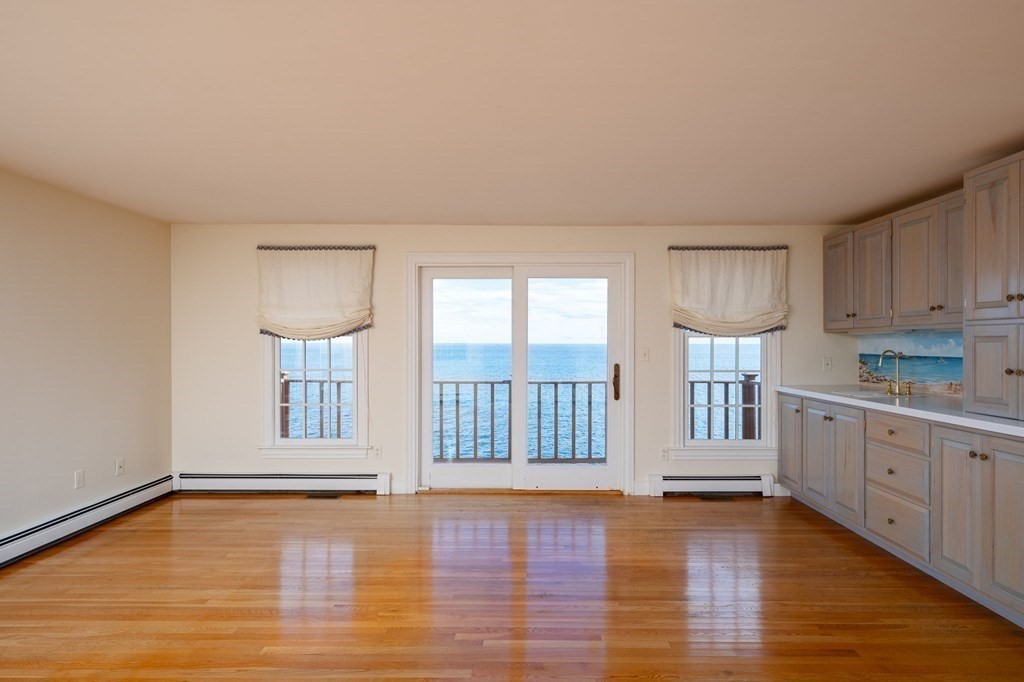 475 Jerusalem Road Cohasset, MA 02025 - Photo 20 of 41 a large white kitchen with white cabinets and wooden floor