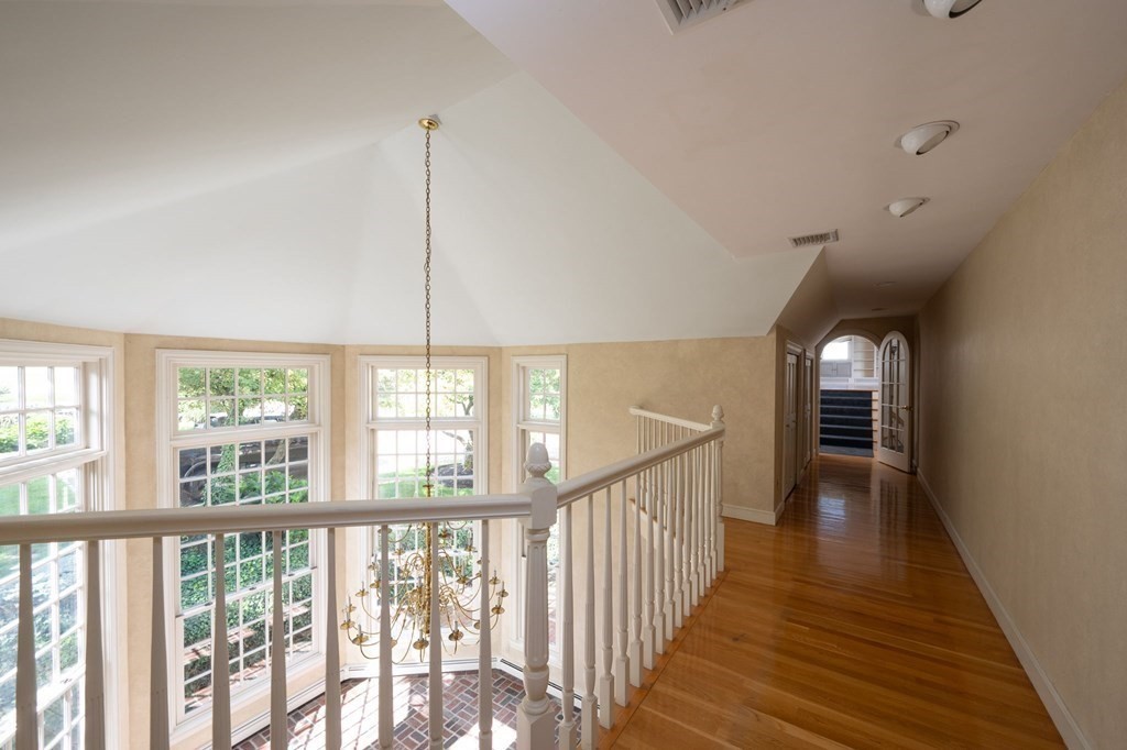 475 Jerusalem Road Cohasset, MA 02025 - Photo 29 of 41 a view of a hallway with wooden floor and windows